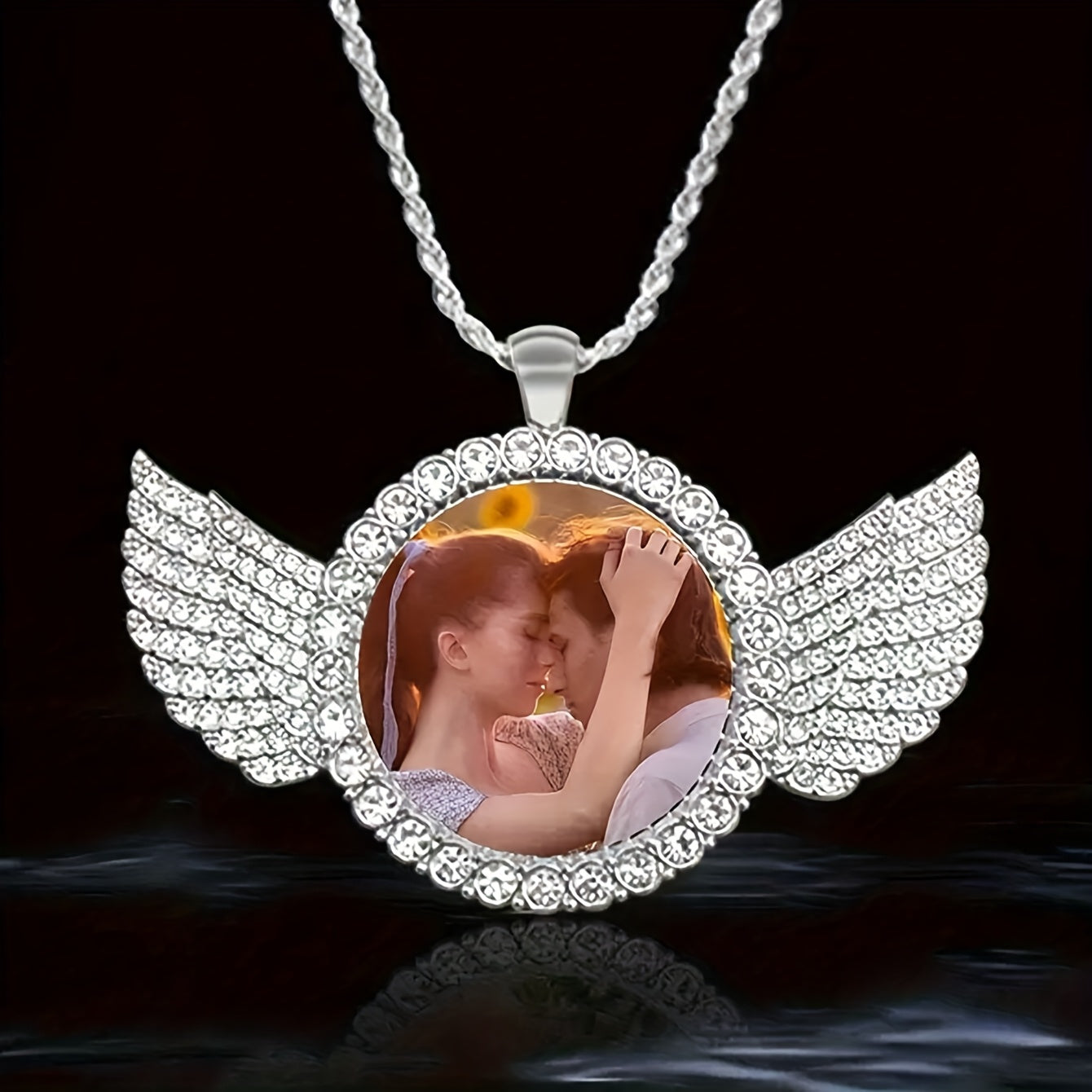 Customizable angel necklace with photo pendant featuring a couple embracing and sparkling wing details.