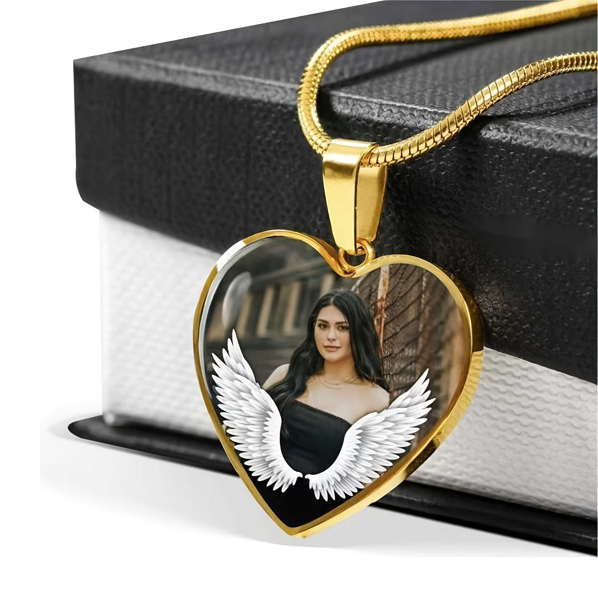 Personalized memorial pendant featuring a heart shape with angel wings and a photo of a woman, symbolizing remembrance.