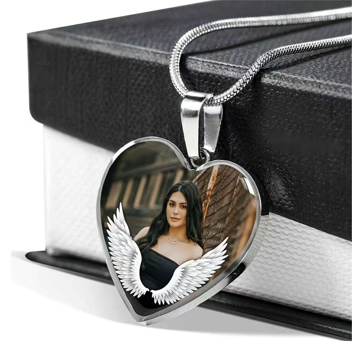 Personalized memorial pendant featuring a heart shape with an angel guardian design and a photo, symbolizing remembrance.